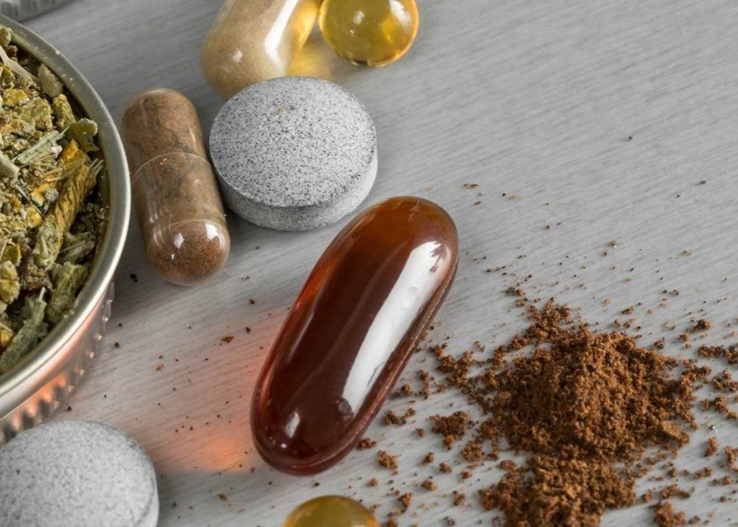 Nutraceuticals and vitamins, tablets, and powder on table
